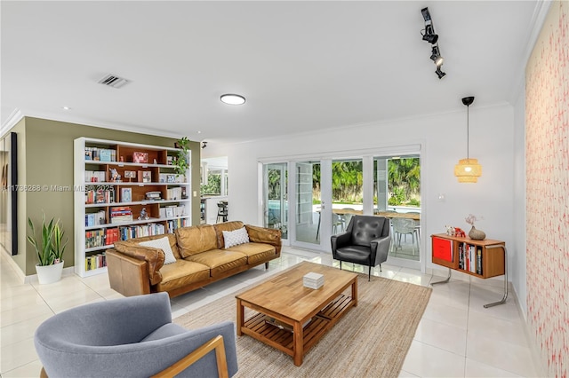 living area featuring visible vents, ornamental molding, rail lighting, french doors, and light tile patterned flooring