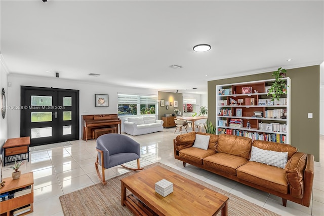 living room featuring visible vents, french doors, crown molding, and light tile patterned flooring