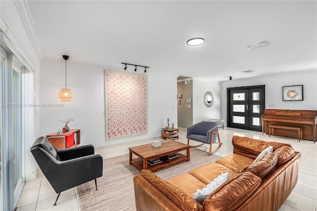 living area with french doors, crown molding, light tile patterned floors, rail lighting, and visible vents