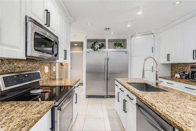 kitchen featuring light tile patterned floors, stainless steel appliances, a sink, white cabinets, and open shelves