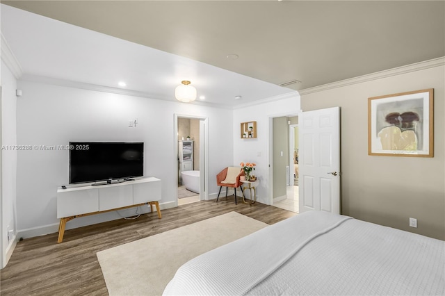 bedroom with recessed lighting, wood finished floors, baseboards, ornamental molding, and ensuite bath