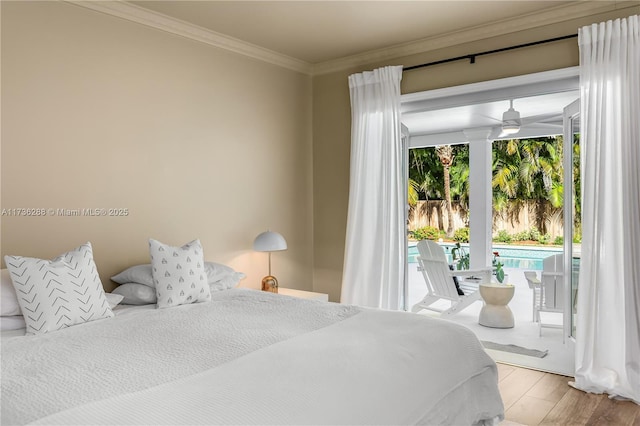 bedroom with access to outside, ornamental molding, and wood finished floors