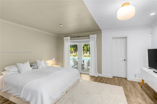 bedroom featuring baseboards, ornamental molding, light wood-style flooring, and access to exterior