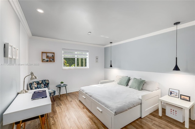 bedroom with ornamental molding, recessed lighting, and wood finished floors