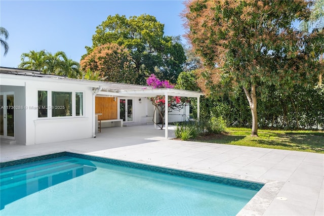 outdoor pool featuring a patio and french doors