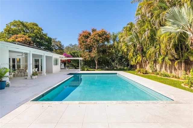 view of pool with french doors, a patio area, fence, and a fenced in pool