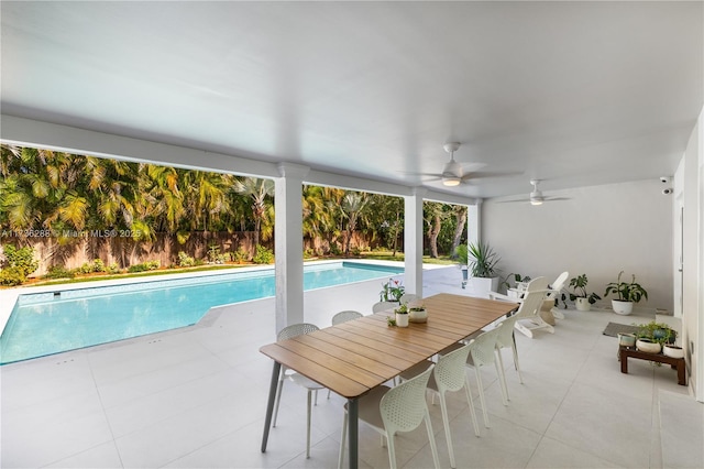 view of swimming pool featuring a fenced in pool, a ceiling fan, a patio, fence, and outdoor dining area