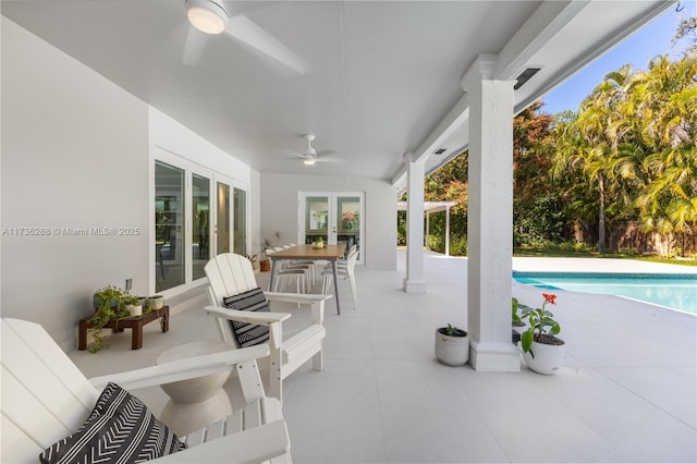 view of patio featuring ceiling fan, an outdoor pool, and french doors