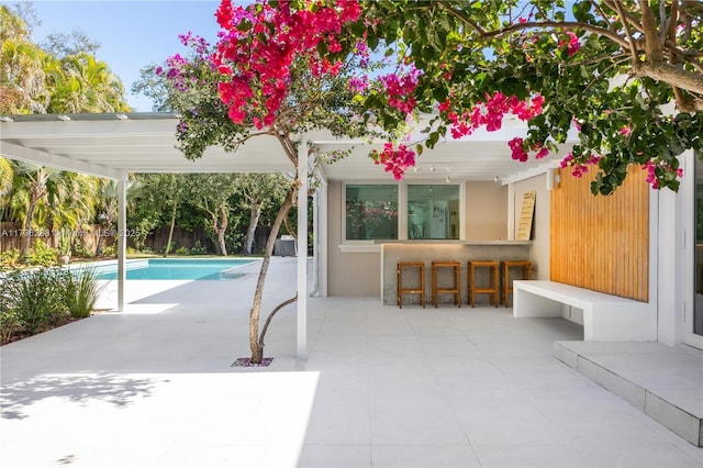 view of swimming pool with a fenced in pool, a patio area, and outdoor dry bar