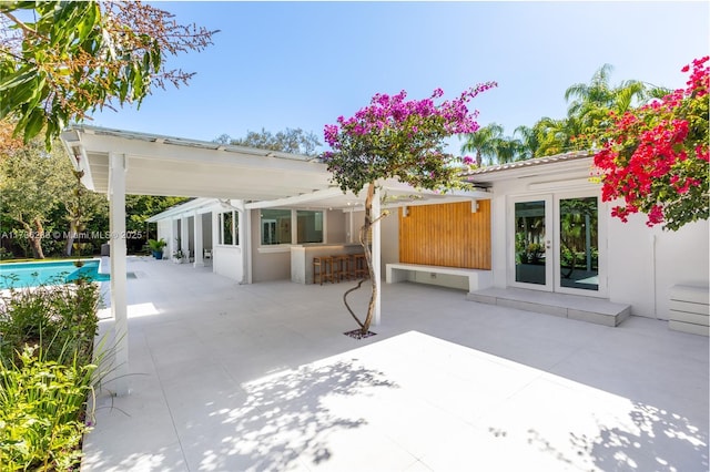 view of patio with a fenced in pool and french doors