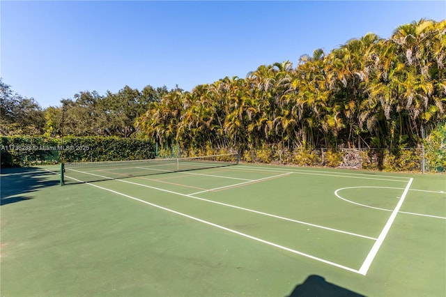 view of tennis court featuring fence