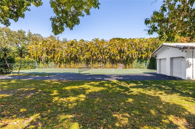 exterior space featuring a tennis court and a yard