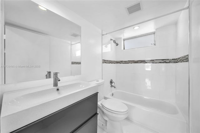 full bathroom featuring vanity, toilet, and tiled shower / bath