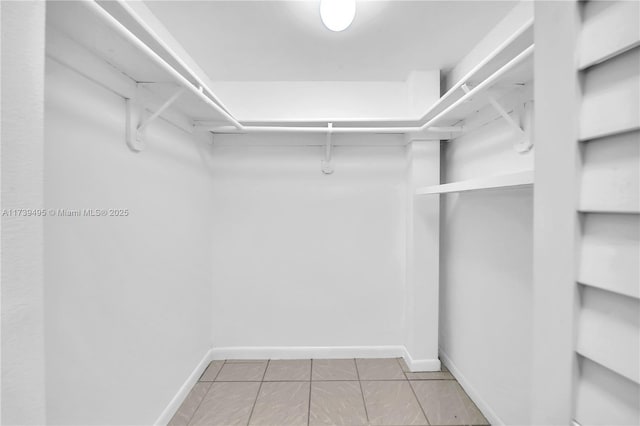 walk in closet featuring tile patterned flooring