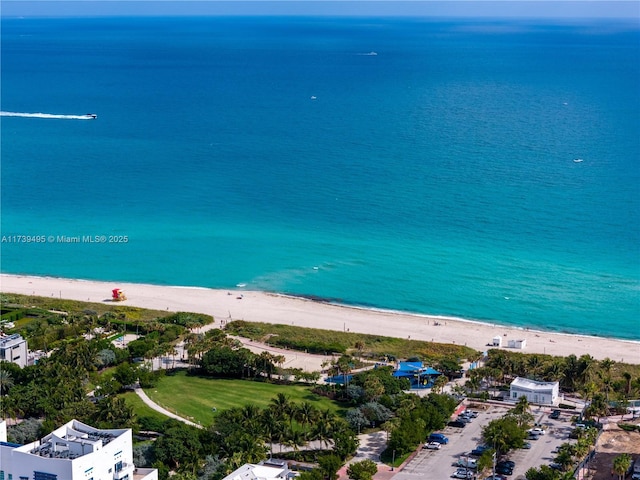 drone / aerial view featuring a water view and a beach view