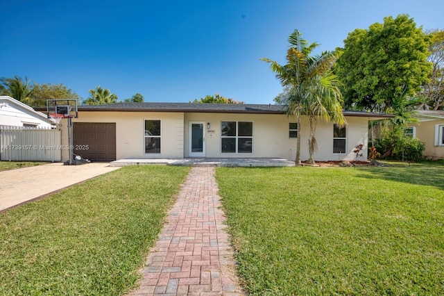 ranch-style house with an attached garage, stucco siding, decorative driveway, and a front yard