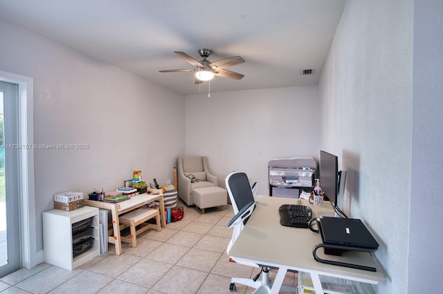 office with light tile patterned floors, visible vents, and a ceiling fan