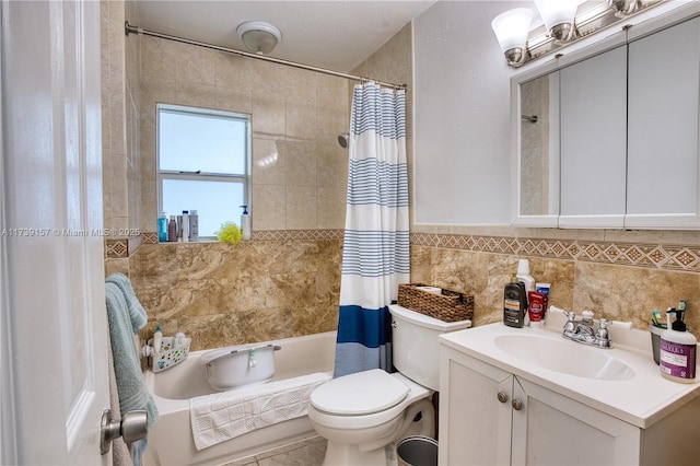 bathroom featuring toilet, shower / tub combo, tile walls, and vanity