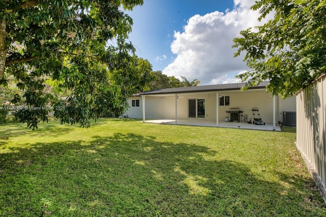 back of house featuring a patio, fence, cooling unit, and a yard