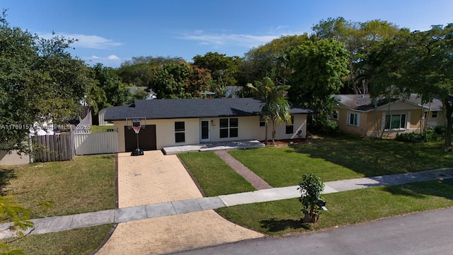 single story home featuring a front yard, fence, and stucco siding