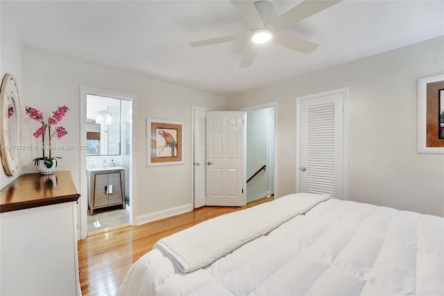 bedroom featuring connected bathroom, light hardwood / wood-style flooring, and ceiling fan