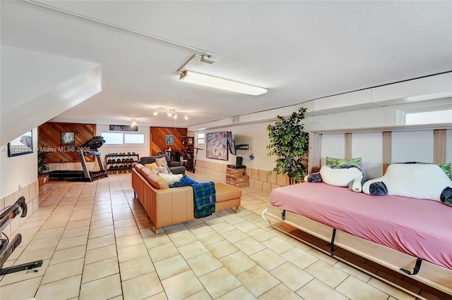 tiled bedroom with rail lighting and wooden walls