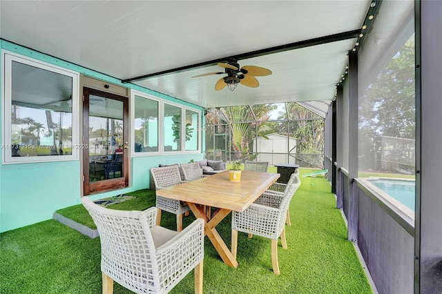 sunroom / solarium featuring ceiling fan