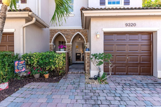 doorway to property with a garage