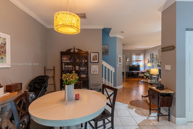 tiled dining space with ornamental molding