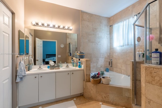 bathroom with vanity and shower with separate bathtub