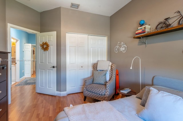 bedroom featuring light hardwood / wood-style floors and a closet