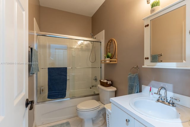 full bathroom with vanity, toilet, tile patterned flooring, and combined bath / shower with glass door