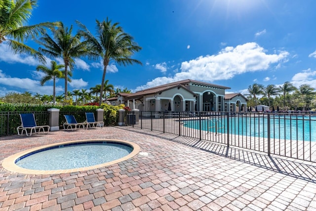 view of pool with a patio and a jacuzzi