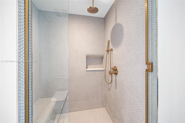 bathroom with a tile shower