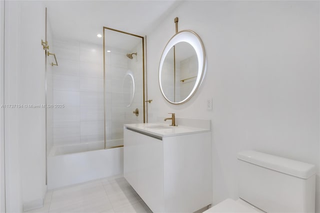 full bathroom featuring tiled shower / bath combo, vanity, tile patterned flooring, and toilet