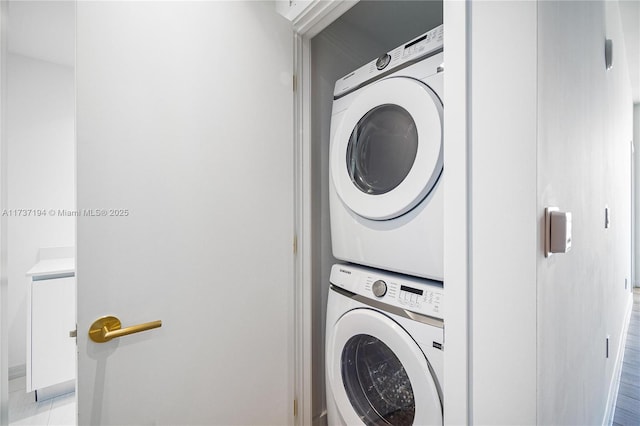 laundry room featuring stacked washer / drying machine