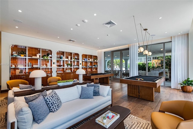 living room featuring hardwood / wood-style floors, pool table, and french doors