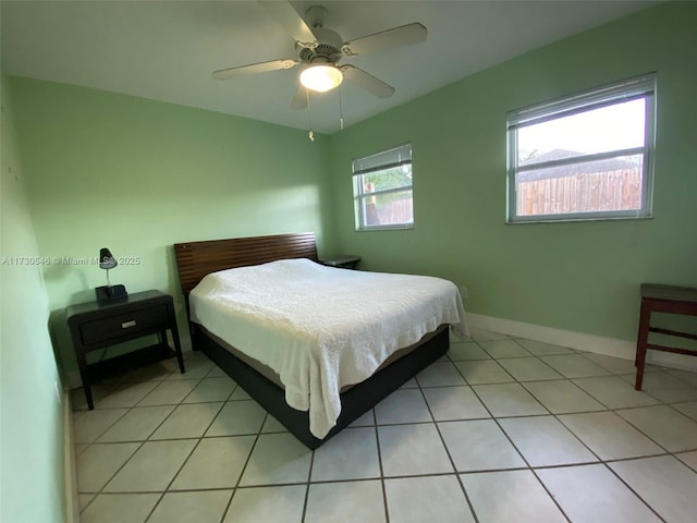 tiled bedroom featuring ceiling fan