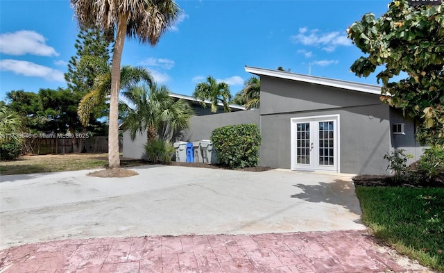 rear view of house with a patio area and french doors