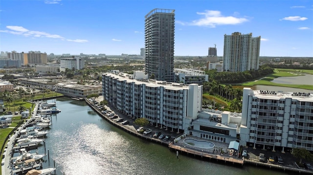 birds eye view of property with a water view and a city view