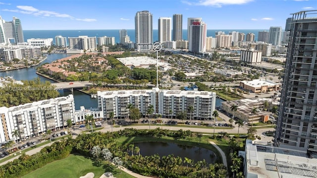 birds eye view of property featuring a water view and a city view