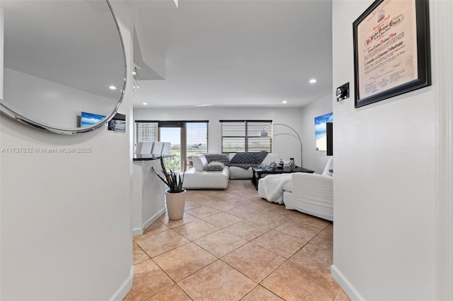 living room with light tile patterned floors, recessed lighting, and baseboards