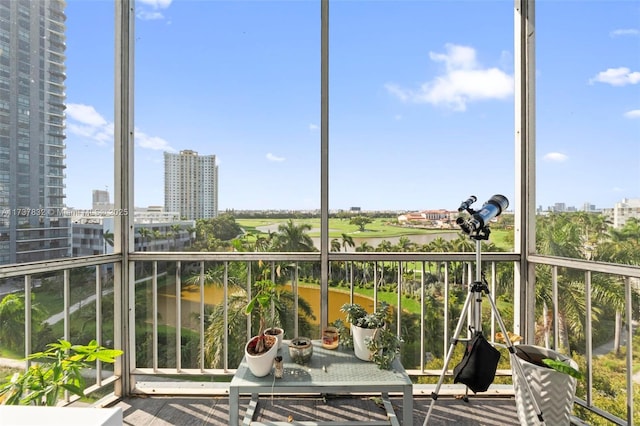 unfurnished sunroom with a water view and a city view