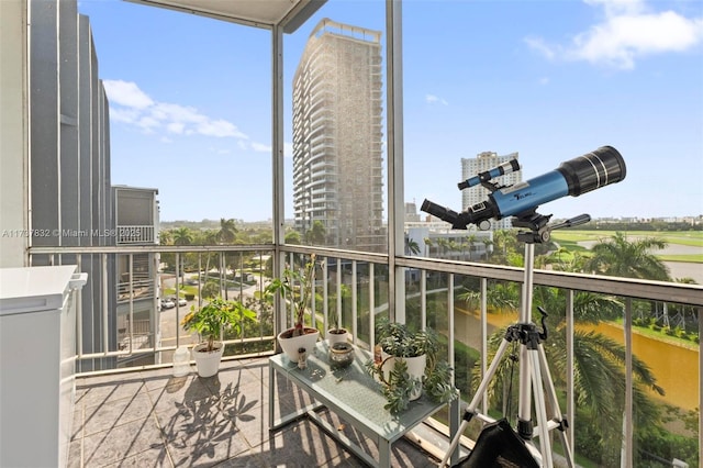 balcony featuring a city view and a water view