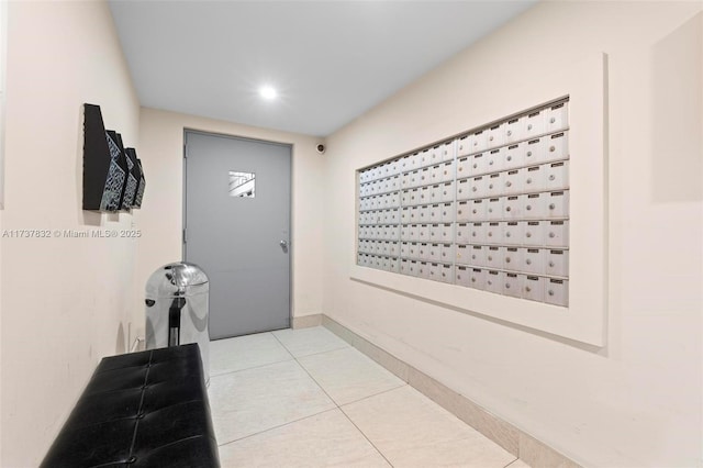 interior space featuring baseboards, mail area, and tile patterned floors