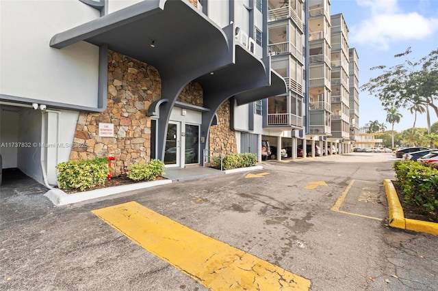 view of building exterior featuring uncovered parking