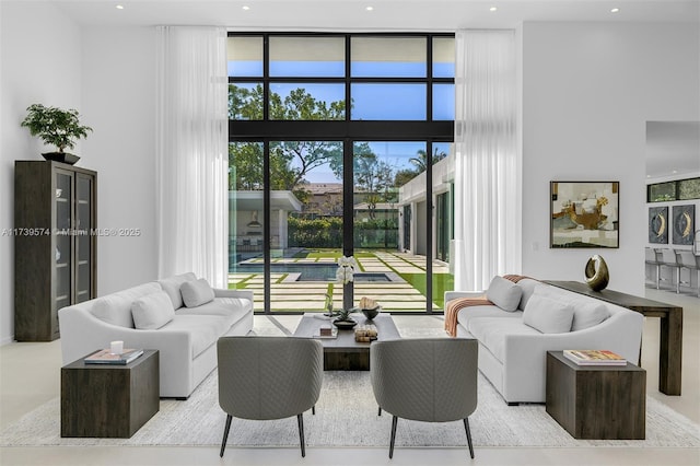 living room with expansive windows and a high ceiling