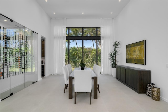 dining area featuring a towering ceiling