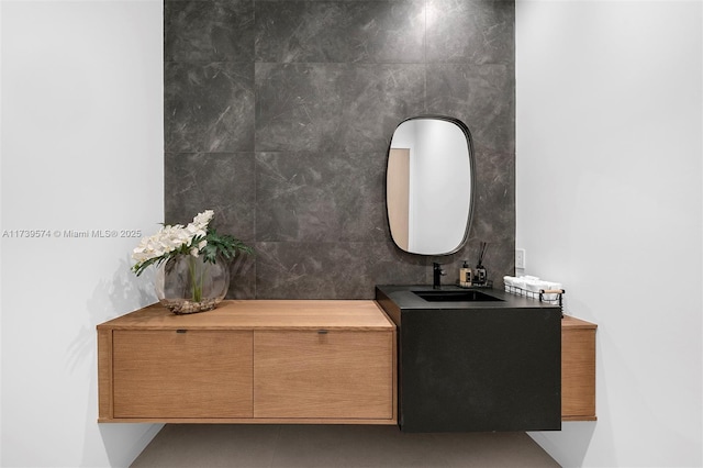 bathroom with vanity and tile walls