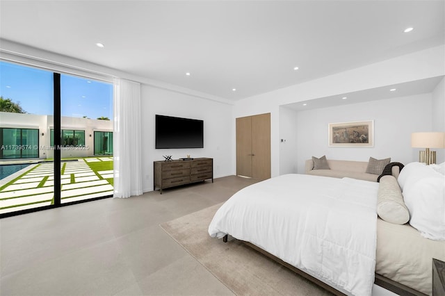 bedroom featuring expansive windows and access to outside